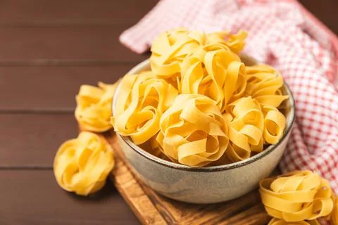 Assorted uncooked pasta in bowls. Stock Photos
