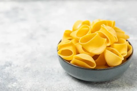 Assorted uncooked pasta in bowls. Stock Photos