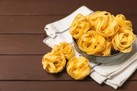 Assorted uncooked pasta in bowls. Stock Photos
