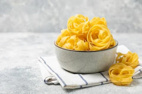 Assorted uncooked pasta in bowls. Stock Photos