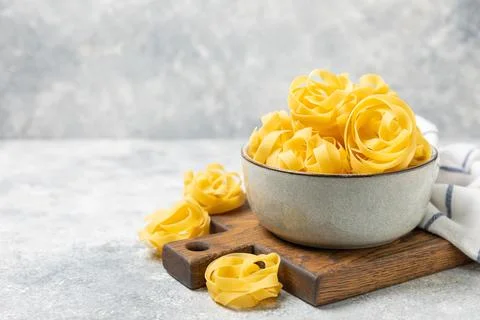 Assorted uncooked pasta in bowls. Stock Photos