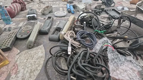 Assorted used electronic accessories and household components arranged across Stock Footage 346083700
