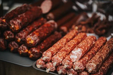 Assorted varieties of cured sausages displayed on a table, showcasing diffe.. Stock Photos