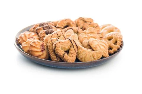 Assorted various cookies. Sweet biscuits on plate isolated on white backgroun Stock Photos