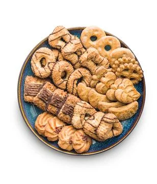 Assorted various cookies. Sweet biscuits on plate isolated on white backgroun Stock Photos