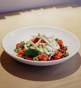 Assorted vegetable salad, apple, and burrata cheese Stock Photos