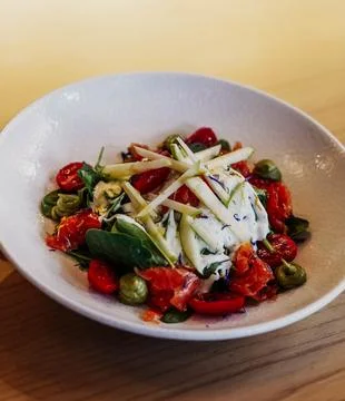 Assorted vegetable salad, apple, and burrata cheese Stock Photos