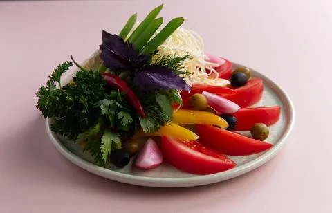 Assorted vegetables and various cheeses in a plate. Stock Photos
