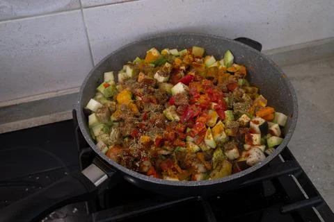 Assorted vegetables are fried in a pan. Colorful healthy food. Stockfoto's