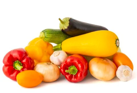 Assorted vegetables from bright ripe appetizing fruits on a white background Stock Photos
