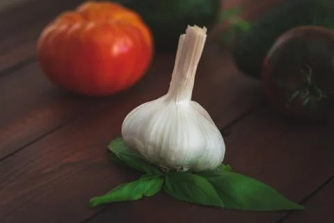 Assorted vegetables on a brown board for farm-to-table messaging. Stock Photos