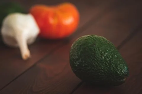 Assorted vegetables on a brown board for farm-to-table messaging. Stock Photos