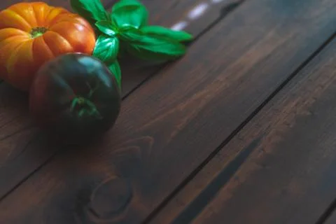 Assorted vegetables on brown table great for farm to table marketing. Stock Photos