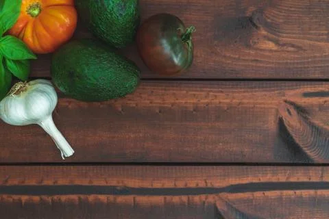 Assorted vegetables on brown table great for farm to table marketing. Stock Photos