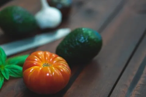 Assorted vegetables on brown table great for farm to table marketing. Stock Photos