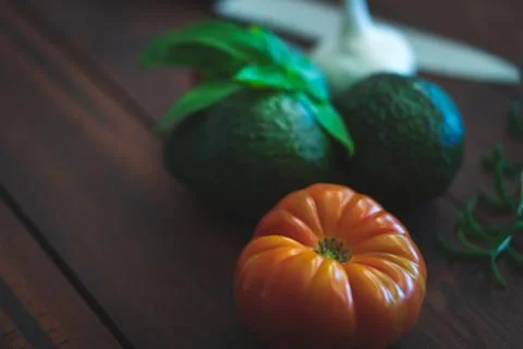 Assorted vegetables on brown table great for farm to table marketing. Stock Photos