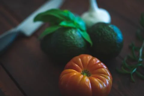 Assorted vegetables on brown table great for farm to table marketing. Stock Photos
