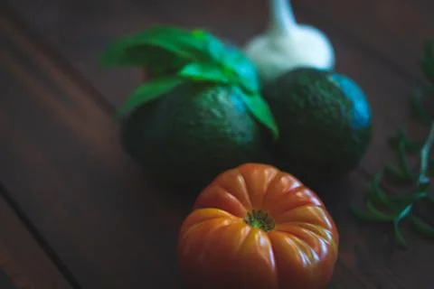 Assorted vegetables on brown table great for farm to table marketing. Stock Photos