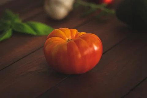 Assorted vegetables on brown table great for farm to table marketing. Stock Photos