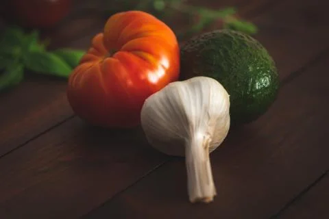 Assorted vegetables on brown table great for farm to table marketing. Stock Photos
