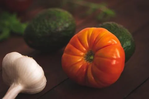 Assorted vegetables on brown table great for farm to table marketing. Stock Photos