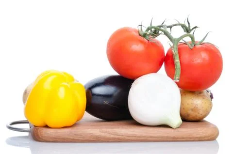 Assorted Vegetables on a Cutting Board on White Background Stock Photos