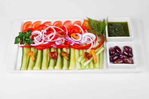 Assorted vegetables with sliced cucumber, tomatoes, chili, onion, olive and m Stock Photos
