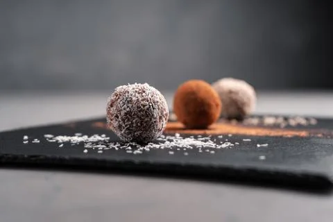 Assorted vegetarian date sweets on a slate Board on a gray concrete table close Stock Photos