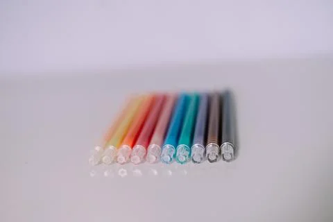 Assorted vibrant markers arranged on pristine surface for creative endeavors Stock Photos