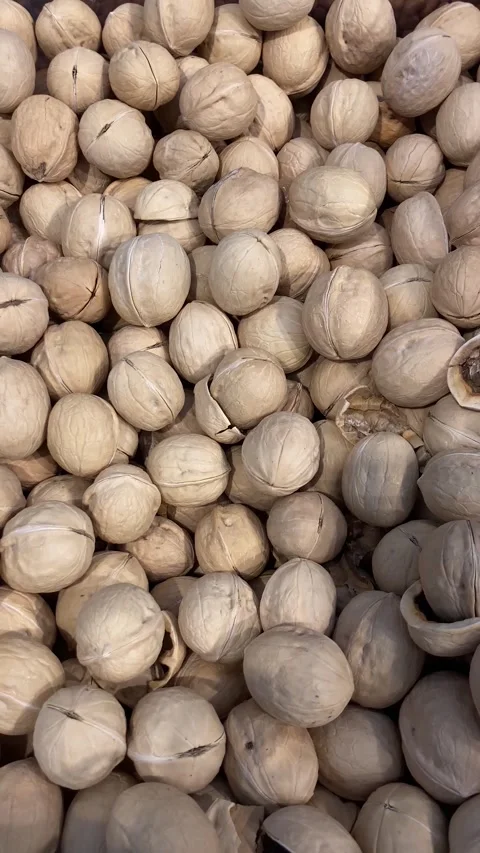Assorted Walnuts In Shell Piled High For Bulk Grocery, Cooking, And Healthy Stock Footage 328456927
