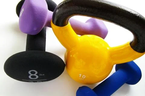 Assorted weights arranged on a white background Stock Photos