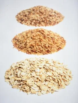 Assorted whole grains including quinoa, brown rice, and oats in separate mo.. Stock Photos