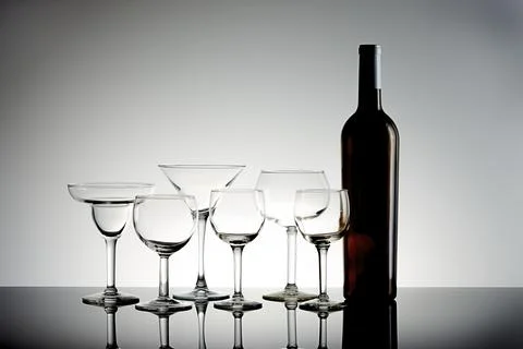 Assorted wine glasses and bottle. Stock Photos