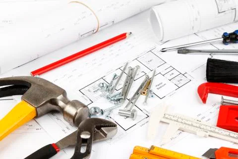 Assorted work tools on building plans Stock Photos