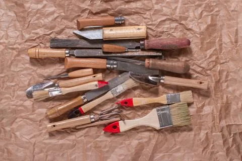 Assorted work tools on crumpled craft paper Stock Photos