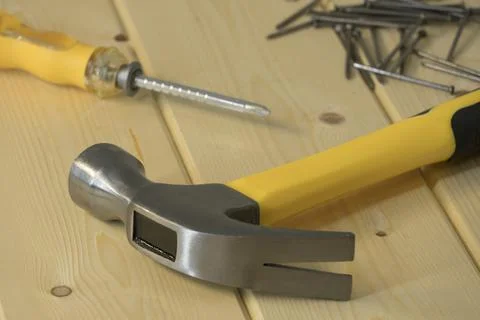 Assorted work tools on wood. Hand tools on a wooden background, hammer with n 库存照片