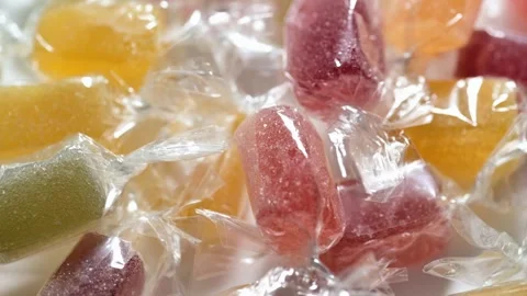 Assorted wrapped jelly candies close up with rotation. Video stock 277871391