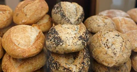 Assortment of baked bread in a bakery window display Stock Photos