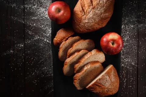 Assortment of baked bread from rye and wheat flour on black background. Top view Stock Photos
