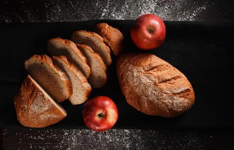Assortment of baked bread from rye and wheat flour on black background. Top view Stock Photos