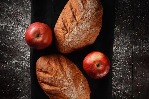 Assortment of baked bread from rye and wheat flour on black background. Top view Stock Photos