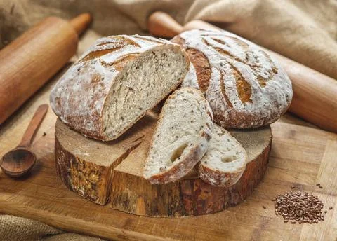 Assortment of baked bread from rye and wheat flour on wooden background Stock Photos