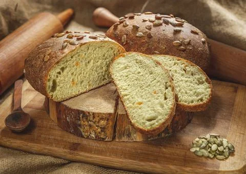 Assortment of baked bread from rye and wheat flour on wooden background Stock Photos