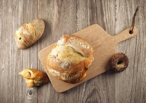 Assortment of baked bread on wood table Stock Illustration