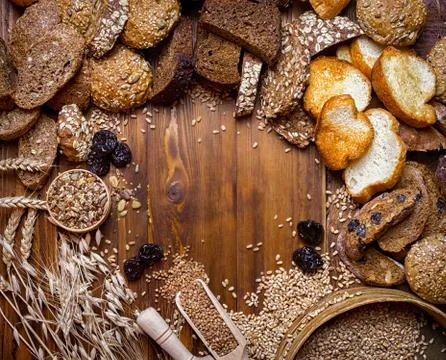Assortment of baked bread on wooden table background Stock Photos