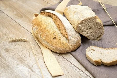 Assortment of baked crisp bread and cutted slice of baguette on table with .. Stock Photos