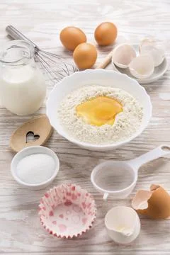 Assortment of basic baking ingredients for cake or pancakes on wooden background Stock Photos