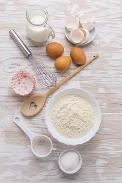 Assortment of basic baking ingredients for cake or pancakes on wooden background Stock Photos