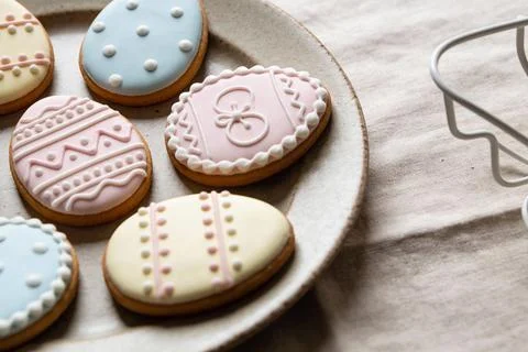 Assortment of beautifully decorated Easter egg shaped sugar cookies on a plat Stock Photos