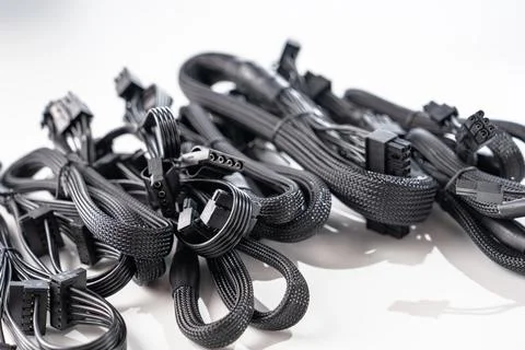 Assortment of Black Computer Cables for Power Supply Units on White Background Stock Photos